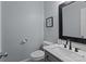 Charming powder room with stylish fixtures, decorative mirror, and modern vanity at 116 Jim Parker Rd, Wesley Chapel, NC 28110