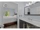 A bathroom sink vanity features decorative doors, a large mirror and an open doorway to the bedroom at 116 Jim Parker Rd, Wesley Chapel, NC 28110