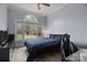 Cozy bedroom with large window offering natural light and treetop views at 116 Jim Parker Rd, Wesley Chapel, NC 28110