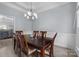 Well-lit dining room with a dark wood table and white wainscotting at 116 Jim Parker Rd, Wesley Chapel, NC 28110