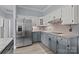 Kitchen boasts stainless steel refrigerator, white cabinets, tile backsplash, and granite counters at 116 Jim Parker Rd, Wesley Chapel, NC 28110