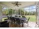 Spacious screened porch with an outdoor dining area and scenic backyard views at 116 Jim Parker Rd, Wesley Chapel, NC 28110