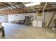 Unfinished basement with washer, dryer, refrigerator, and utility shelving unit at 119 Harbor Ln, Mount Gilead, NC 27306
