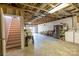 Unfinished basement with concrete floor, exposed ceiling, and stairs to upper level at 119 Harbor Ln, Mount Gilead, NC 27306