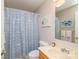 Well-lit bathroom featuring a vanity, toilet, and shower with a patterned blue curtain at 119 Harbor Ln, Mount Gilead, NC 27306