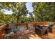 Spacious wooden deck with outdoor seating, overlooking the serene lake and lush greenery at 119 Harbor Ln, Mount Gilead, NC 27306
