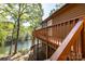 Waterfront home featuring a wooden deck with railings, offering stunning lake views at 119 Harbor Ln, Mount Gilead, NC 27306