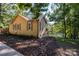 Cozy waterfront home with brown siding, white window trim, stone foundation, and mature trees at 119 Harbor Ln, Mount Gilead, NC 27306