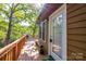 Lake home exterior, featuring a deck with outdoor seating and a scenic lake view at 119 Harbor Ln, Mount Gilead, NC 27306
