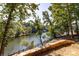 Scenic lake view with lush greenery surrounding the waterfront property at 119 Harbor Ln, Mount Gilead, NC 27306