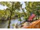 Scenic lake view from the deck with American flag and surrounding mature trees at 119 Harbor Ln, Mount Gilead, NC 27306