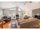 Open living room with vaulted ceilings, a fireplace, hardwood floors, and deck access at 119 Harbor Ln, Mount Gilead, NC 27306