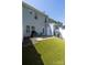 Spacious backyard with synthetic turf, patio, and views of the home's back exterior at 121 Talbert Town Loop, Mooresville, NC 28117