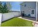 Backyard featuring a white fence, patio, synthetic turf, and partial view of the home at 121 Talbert Town Loop, Mooresville, NC 28117