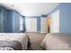 Bright bedroom featuring two beds, soft blue walls and a closet at 121 Talbert Town Loop, Mooresville, NC 28117