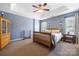 Bright bedroom with a ceiling fan, carpeted floors, a wooden bed frame, and lots of natural light at 121 Talbert Town Loop, Mooresville, NC 28117