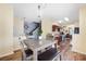 Inviting dining area showcasing wood floors, an elegant light fixture, and seamless flow to kitchen and living spaces at 121 Talbert Town Loop, Mooresville, NC 28117