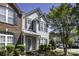 Charming townhouse featuring a blend of brick and siding, complemented by well-maintained landscaping and a welcoming entrance at 121 Talbert Town Loop, Mooresville, NC 28117