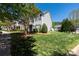 Scenic view of townhouses with lush green lawns, mature trees, and well-maintained landscaping on a bright, sunny day at 121 Talbert Town Loop, Mooresville, NC 28117