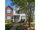 Lovely townhouse showcasing a mix of brick and siding, complemented by manicured landscaping and an inviting entryway at 121 Talbert Town Loop, Mooresville, NC 28117