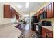 Efficient kitchen layout featuring dark wood cabinets, modern appliances, and seamless transition into adjacent living areas at 121 Talbert Town Loop, Mooresville, NC 28117