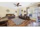 Inviting living room with hardwood floors, a ceiling fan, and comfortable leather furniture at 121 Talbert Town Loop, Mooresville, NC 28117