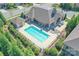 Aerial view of a community pool with lounge chairs, tables, and a shaded seating area for residents' enjoyment at 1231 Restoration Dr, Marvin, NC 28173