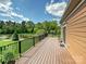 Expansive wooden deck overlooking a serene pond surrounded by lush greenery and mature trees at 1231 Restoration Dr, Marvin, NC 28173