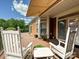 Large deck with awning, perfect for outdoor seating and enjoying the view of the trees and the yard at 1231 Restoration Dr, Marvin, NC 28173