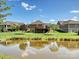 Spacious backyard featuring lush green grass and a tranquil pond view in the community at 1231 Restoration Dr, Marvin, NC 28173