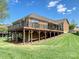 Backyard with an elevated deck, patio, and well-manicured lawn at 1231 Restoration Dr, Marvin, NC 28173