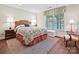 Bedroom showcasing a floral patterned bed, side tables with lamps, and a window with natural light at 1231 Restoration Dr, Marvin, NC 28173