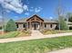 Community clubhouse with stone accents, craftsman-style columns, landscaped grounds, and concrete walkway at 1231 Restoration Dr, Marvin, NC 28173