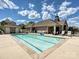 Community pool featuring clear blue water, pool house, lounge chairs, and landscaped surroundings at 1231 Restoration Dr, Marvin, NC 28173