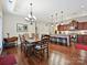 Open-concept dining and kitchen area with hardwood floors, modern appliances, and ample seating for entertaining at 1231 Restoration Dr, Marvin, NC 28173