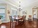 A beautiful dining room with hardwood floors, natural light, and a large table at 1231 Restoration Dr, Marvin, NC 28173