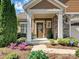 Inviting front porch featuring stone accents, decorative wreath, and manicured landscaping enhancing curb appeal at 1231 Restoration Dr, Marvin, NC 28173