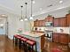 Well-appointed kitchen with granite countertops, stainless steel appliances, and a breakfast bar with seating at 1231 Restoration Dr, Marvin, NC 28173