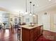 The kitchen boasts an island with a sink, wooden cabinets, stainless dishwasher, and a breakfast bar at 1231 Restoration Dr, Marvin, NC 28173