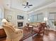 Comfortable living room featuring a fireplace, large windows, hardwood floors, and stylish furnishings at 1231 Restoration Dr, Marvin, NC 28173