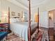 The main bedroom includes a canopy bed, hardwood floors, and an ensuite bathroom at 1231 Restoration Dr, Marvin, NC 28173
