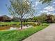 Scenic view of a pond with a fountain, mature trees, and a walking path in the community at 1231 Restoration Dr, Marvin, NC 28173