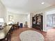 Spacious room featuring a round rug, desk, bookshelves, and a table with chairs, all with wood-look flooring at 1231 Restoration Dr, Marvin, NC 28173