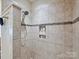 The bathroom has a walk-in shower with tiled walls and a built-in niche at 1231 Restoration Dr, Marvin, NC 28173