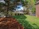 Backyard features a lush lawn with a fenced perimeter, landscaped shrubbery, and mature trees at 126 Pointer Se Ct, Concord, NC 28025
