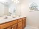 Bright bathroom featuring a large mirror, double sink vanity, and natural light at 126 Pointer Se Ct, Concord, NC 28025