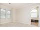 Bright bedroom with neutral walls and flooring, adjacent to the main bath with a jacuzzi tub at 126 Pointer Se Ct, Concord, NC 28025