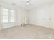 Minimalist bedroom with a neutral palette, natural light, and carpet flooring at 126 Pointer Se Ct, Concord, NC 28025