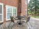 Covered deck with a dining table and chairs next to the brick exterior at 126 Pointer Se Ct, Concord, NC 28025