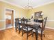 Traditional dining room with hardwood floors, chandelier lighting, and an adjacent view into the kitchen at 126 Pointer Se Ct, Concord, NC 28025